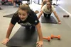 Alden Boland, front, and Alina Cook, who is exercising right behind Boland, joined the GirlForce program sponsored nationally by Jazzercise and held locally at the Eagle River Jazzercise stud