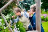 Visitors at the 9th Palmer Museum Garden &amp; Art Faire enjoy the flowers in the visitor center garden. The event hosted an array of booths, food carts and attractions catering to all ages. 