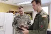 Air Force Capt. John Harris (right), 3rd Operations Support Squadron C-17 pilot and air-refueling schedule manager, explains the route Tech. Sgt. Andrew Winders, 673d Medical Group Inpatient 