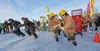 The three race teams make a mad dash from the start line at the 2025 Willow Winter Carnival Outhouse Race on Willow Lake. Proceeds from the Willow Area Community Organization Taste the Fest S
