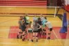C-team coach Katie Oxspring huddles with her players on the gym floor. C-team players form the foundation for future junior varsity and varsity teams. Jesslyn Zhart