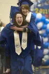 A pair of Palmer High School graduates enter their ceremony with
one carrying the other. The 2011 graduating class totaled 144
students. (ROBERT DeBERRY/Frontiersman)
