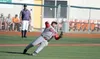 Wasilla pitcher Hank Boyer slips to the turf as he makes the throw to first after a Kenai bunt during a 4-3 loss to the Twins Thursday, July 28, 2016, at Mulcahy Stadium in Anchorage. JEREMIA