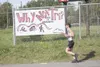 Competitor No. 141 passes a sign advertising the second annual
Why Not Tri Wasilla Triathlon at Wasilla High School. The event
included a swimming portion in the school’s pool, followed by
cy