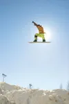 MATT TUSNETH/Frontiersman Pro snowboarder Travis Parker soars in
the sunshine Tuesday behind Wasilla Middle School. Parker and four
other skiers and boarders took part in Shred Fest 2007, a p