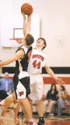 ROBERT DeBERRY/Frontiersman Houston Hawk Colton Buzby takes on
Kenai’s Tyler Spalding for a jump ball during Friday’s game at
Houston High School.