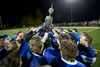 Members of the Palmer High School football team hold up the Mayor's Cup after defeating the Wasilla Warriors 41-12 to reclaim the title during the 34th annual Potato Bowl at Machetanz Field i