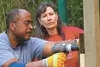 Simon Fair and Sharon Scott work together to put up a fence surrounding the new Alpine Playground in Sutton next to the Historical Park. The playground is the result of a community-wide effor