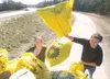 ROBERT DeBERRY/Frontiersman Mid-Valley High School seniors
Miranda Sheldon, 18 and Jacob Toney, 19 toss trash bags in the back
of a pickup Friday afternoon along the Parks Highway near
Housto