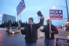 Republican U.S. House candidate Nick Begich, with sign-holding supporters, waves to Midtown Anchorage motorists on Election Day.  Yereth Rosen/Alaska Beacon