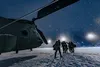 U.S. Army aircrew from Company B, 2nd Battalion, 238th General Support Aviation, Peoria, Ill., walks away from their CH-47 “Chinook” after a night mission during Winter Strike 21 at Alpena Co