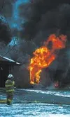 A firefighter stands ready while flames roar through the
dwelling. Photos courtesy of Central Mat-Su Fire Department.