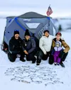 A group shows off their catch during a Drill Team Six ice fishing trip.  Photo courtesy of Drill Team Six Fishing Excursions