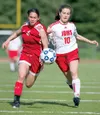 MICHAEL PENN/Juneau Empire Wasilla’s Ashlynn Frizzelle, left,
and Juneau’s Marlena Sloss race for the ball in the second half of
their first-round game Thursday at the ASAA/First National Ban