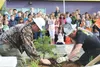 Matanuska Electric Association arborist Bill Jardel and clearing foreman Joel Stefanski teach students at Midnight Sun Charter School how to plant trees as part of an Arbor Day celebration or