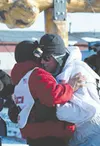 Seventh-place Iditarod finisher Rayme Smyth is congratulated by
fellow Valley resident Linwood Fiedler who finish in sixth place.
JEREMIAH BARTZ/ Frontiersman.