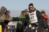 Iditarod veteran Ryan Redington slaps hands with fans as he heads out the starting chute at the start of the 40th running of the Iditarod Trail Sled Dog Race Sunday in Willow. Robert DeBerry