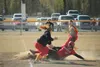 Wasilla High School senior Cassidy Edwards slides into third base just in time during the game against West Valley Thursday evening. The game was still underway as of press time with Wasilla 