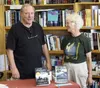 Author Jim Misko, left, and fan/former real estate colleague Jill Parson at Misko’s book signing at Fireside Books in Palmer on Saturday, July 9, 2016. MATT HICKMAN/Frontiersman.com
