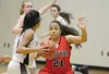 Nikiski Bulldog Arianne Parrish tries to pass around Houton High School Hawk Ashley Apangalook, Saturday, Jan. 17, 2015, at Nikiski Middle-High School in Nikiski, Alaska. Photo by Kelly Sulli
