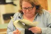 A student concentrates while cutting a pattern out of tanned fish skin at Palmer Junior Middle School April 4. HEATHER A. RESZ/Frontiersman.com