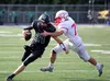 Colony quarterback Ben Alley works to escape the grasp of Wasilla defensive lineman Andrew Devine during a win over the Warriors Friday, Aug. 28, 2020. Jeremiah Bartz/Frontiersman
