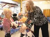 Katherine Losiewski accepts a Quilt of Valor from Marilyn Meiller during a ceremony Thursday at the Alaska Veterans and Pioneers Home in Palmer. ROBERT DeBERRY/Frontiersman