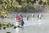 ROBERT DeBERRY/Frontiersman Anglers gather along the bank of the
Knik River at Eklutna Tailrace. The tailrace is exempt from a local
restriction on coho fishing.