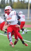 Kenai Kardinals' Kyle Foree tackles Wasilla Warriors' Zach Garnett, Friday, September 12, 2014 at Kenai Central High School in Kenai, Alaska. Photo by Kelly Sullivan/ Peninsula Clarion