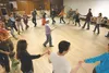 Participants in a Contra dancing class move in a circle around dance instructor Robyn Lauster during Thursday’s class at the Salvation Army in Palmer. Organizers of the class hope it be a reg