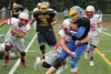 Wasilla junior Aeron Milliron wraps up to make a take during a scrimmage against Bartlett Aug. 5, 2016, at Wasilla High School. This week, the Warriors did something they had not done in near