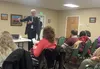 Duane Mayes, director of the Alaska Division of Senior and Disabilities Services, speaks to a group of people during a forum held to discuss Medicaid options for community-based health servic