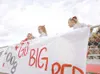 ROBERT DeBERRY/Frontiersman Wasilla cheerleaders Troi Ane Young,
left, Holly Andrews, middle, and Barbara Horman hang signs on the
Wasilla side at Machetanz Field in Palmer Friday before the 