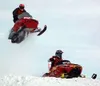 Dennis Johnson, left, flies high off the big jump as Michael
Rosh, right, speeds ahead during the 501-800cc semi-pro class race
in Big Lake Saturday. Photo by TIM BRODT/Frontiersman.
