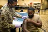 Senior Airman Rendall Powell, 412th Test Wing, receives a COVID-19 vaccination shot from Lt. Col. Yvonne Storey, 412th Medical Group, at the Airman and Family Readiness Center on Edwards Air 