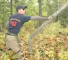 State Forestry employee Ryan Keogh pushes down a dead tree as
part of a brush clearing project near Larson Elementary Thursday.
Keogh is part of a state forestry crew that is clearing dead br
