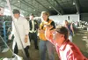Steve Hubacek trys to get a look at the weight of his cabbage as
it is placed on the scale Friday evening at the Alaska State Fair.
ROBERT DeBERRY/Frontiersman