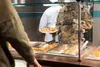 U.S. Air Force Col. Jason Delamater, the 673d Mission Support Group commander, serves soul food to a military member at Iditarod Dining Facility on Joint Base Elmendorf-Richardson, Alaska, Fe