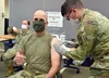 Col. Timothy Walsh, deputy commander for U.S. Army Medical Logistics Command, receives his influenza vaccine during a clinic Oct. 27 at Fort Detrick, Maryland. Administering Walsh's flu shot 