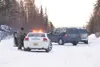 An Alaska State Trooper readies his weapon during a standoff
Saturday afternoon on Wolverine Road. Troopers with assault rifles
surrounded the home in a subdivision north of Bogard Road and e