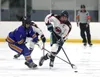 Homer's Zane Barth tries to poke the puck away from Houston's Daniel Matveev during an 8-2 loss to the Hawks Friday, Jan. 17, 2024, at the Menard Arena in Wasilla. Bruce Eggleston/matsusports