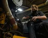 U.S. Air Force Senior Airman Jessica Driver, a 673d Logistics Readiness Squadron Heavy Equipment Shop vehicle maintenance journeyman, repairs a light on an Okosh H-series truck to ensure it i