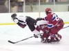 Colony defenseman Morgan McJimsey takes a hit during the first
period of Saturday's game against East High at the Curtis C. Menard
II Memorial Hockey Tournament in Wasilla. (ROBERT
DeBERRY/Fr