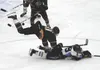 Colony defenseman Kolten Ketchum falls on Chugiak forward Grant Epple as both reach up to grab a loose puck in the air during Chugiak's 5-1 semifinal win over Colony on the second day of the 
