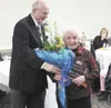 Karl Lund, 2008 Dorothy A. Jones Volunteer of the Year, presents
flowers to the 2009 winner, Helen Munoz. (Courtesy photo)