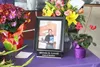 Steve Lovell’s former nameplate stands on a table bearing flowers and photos of the councilman, who died in a heavy equipment accident June 30. The table was part of a memorial for Lovell and