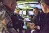 Under Secretary of the Army Ryan D. McCarthy, center left, and Gen. James C. McConville, the Army’s vice chief of staff, center right, discuss emerging technology while inside a Mission Enabl