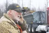 Jim Huston talks on a cell phone about lunchtime Saturday while earth moving equipment rumbles in the background. When borough officials told residents parking lot improvements near the Willo