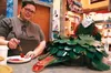 Tara Pollock of the art supply store Forever Endeavor in the Koslosky Center paints a cardboard 'turtle dragon' that doubles as a donation box for the Great Palmer Pantry Push, going on durin