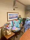 Mat-Su Regional Chief Nursing Officer Shari Giese and another hospital employee pose with some of the homemade PPE donations. Katie Stark/For the Frontiersman